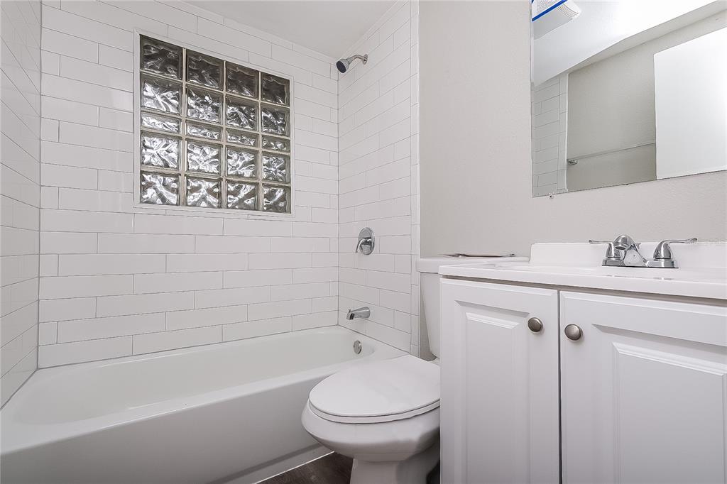 7145 Pinewood Drive New Port Richey, FL 34652 - Photo 14 of 16 a bathroom with a sink a toilet and shower