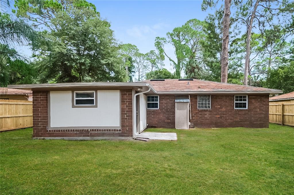 7145 Pinewood Drive New Port Richey, FL 34652 - Photo 15 of 16 front view of a house with a yard