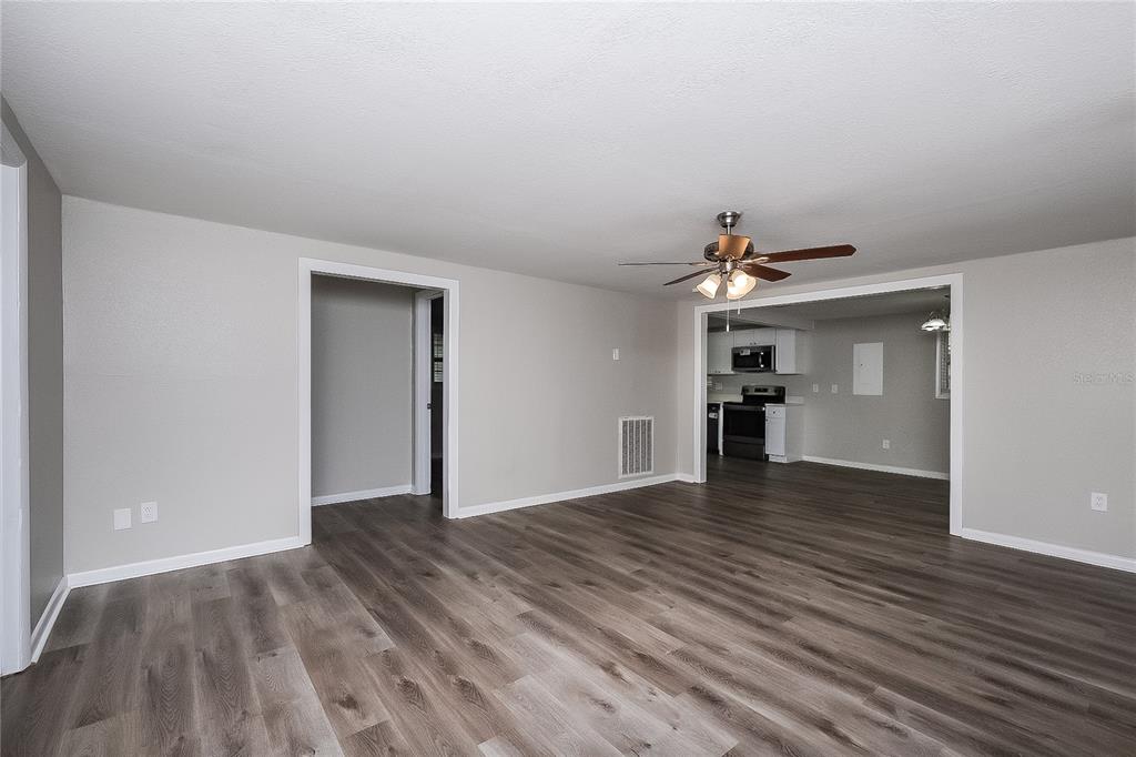 7145 Pinewood Drive New Port Richey, FL 34652 - Photo 3 of 16 a view of empty room with wooden floor