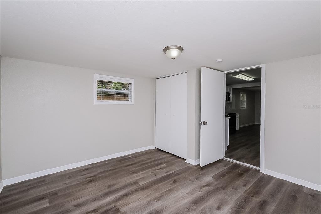 7145 Pinewood Drive New Port Richey, FL 34652 - Photo 7 of 16 an empty room with wooden floor and closet