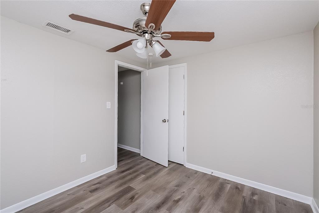 7145 Pinewood Drive New Port Richey, FL 34652 - Photo 8 of 16 a view of an empty room with a fan