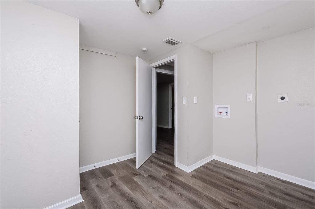 7145 Pinewood Drive New Port Richey, FL 34652 - Photo 10 of 16 a view of an empty room with closet and wooden floor