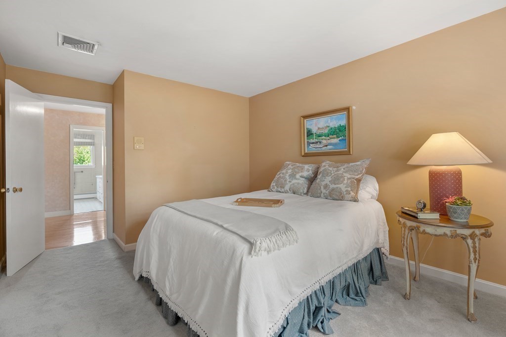 16 Carlton Road Marblehead, MA 01945 - Photo 24 of 42 a bedroom with a bed and a lamp