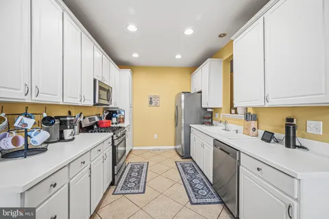 a large white kitchen with a large window