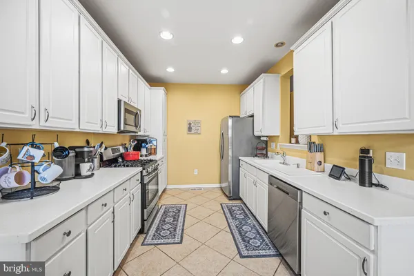 a large white kitchen with a large window