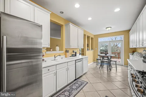 a kitchen with stainless steel appliances a sink and cabinets