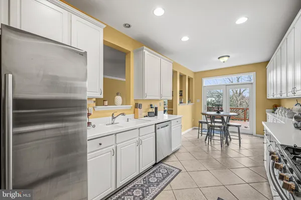 a kitchen with stainless steel appliances a sink and cabinets
