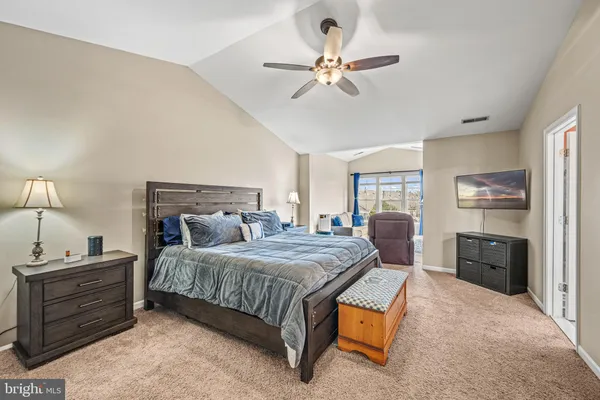 a bedroom with a bed and ceiling fan