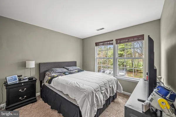 a bedroom with a bed and cabinets