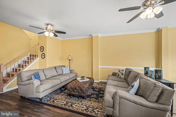a living room with furniture and a chandelier