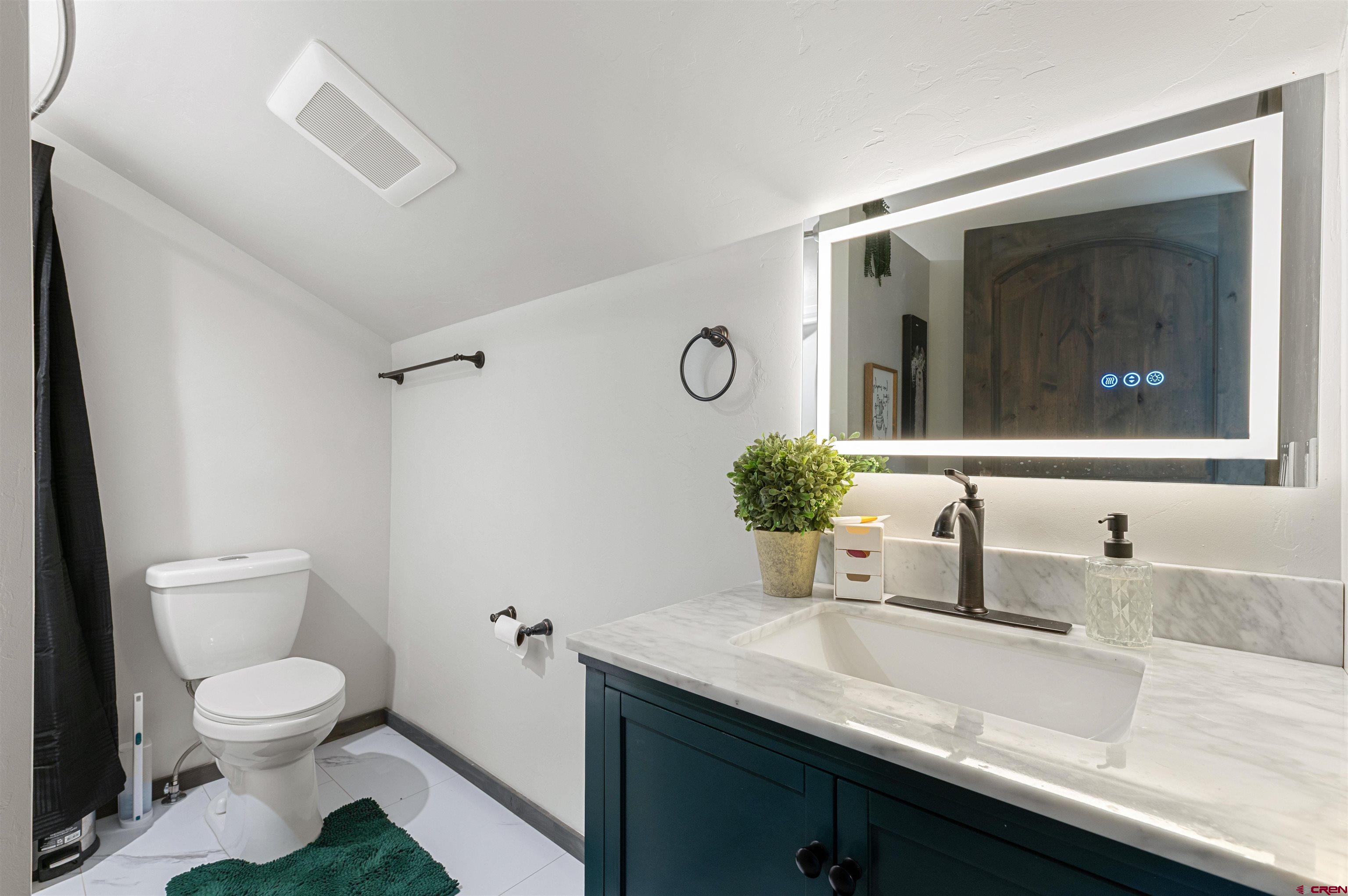 55347 Begonia Road Delta, CO 81416 - Photo 38 of 44 a bathroom with a granite countertop sink a toilet and mirror