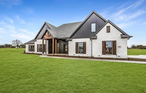 a front view of a house with a garden and porch
