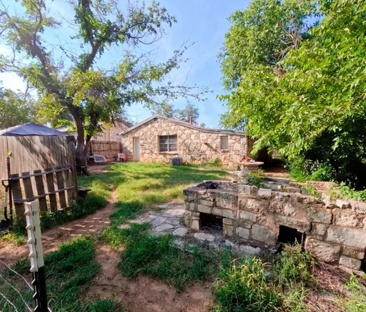 a backyard of a house with table and chairs