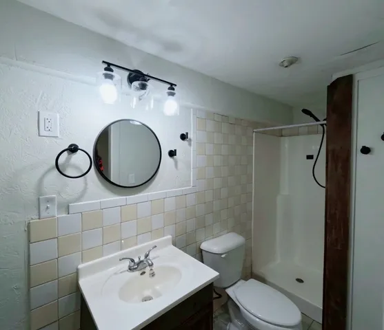 a bathroom with a sink toilet and shower