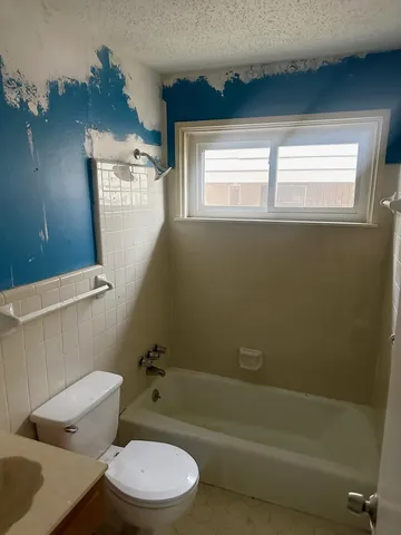 a bathroom with a toilet a sink and bathtub