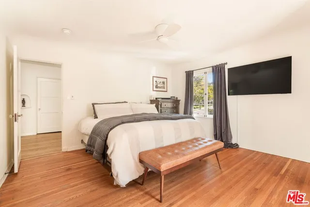 a bathroom with a sink a toilet a window a vanity and shower