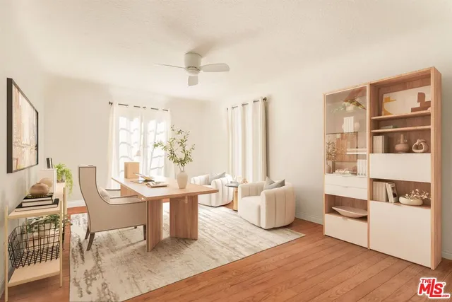 a view of a workspace with furniture and a window