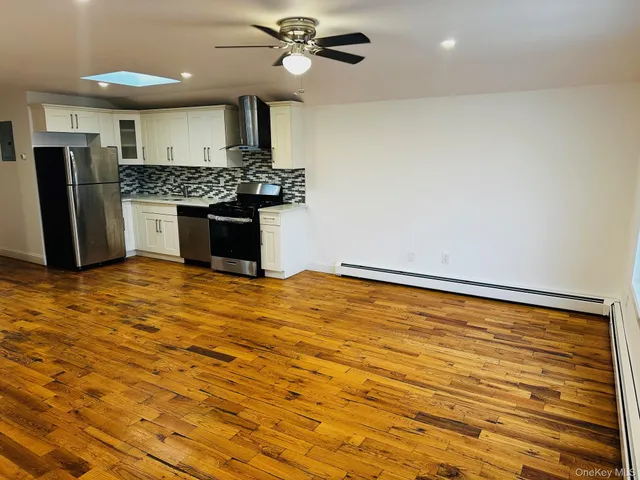 a kitchen with stainless steel appliances granite countertop a sink and cabinets