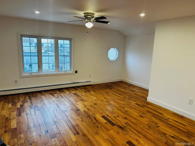 wooden floor in an empty room with a window