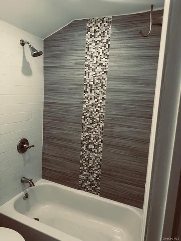 a bathroom with a bathtub and shower