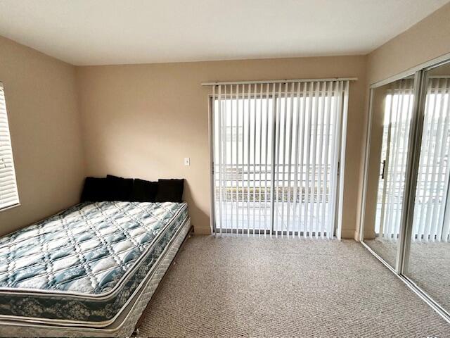 715 Normandy Lane Delray Beach, FL 33484 - Photo 17 of 43 a bed sitting in a bedroom next to a window