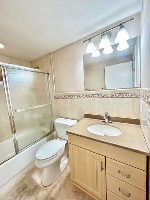 715 Normandy Lane Delray Beach, FL 33484 - Photo 25 of 43 a bathroom with a granite countertop sink toilet a mirror a vanity and shower