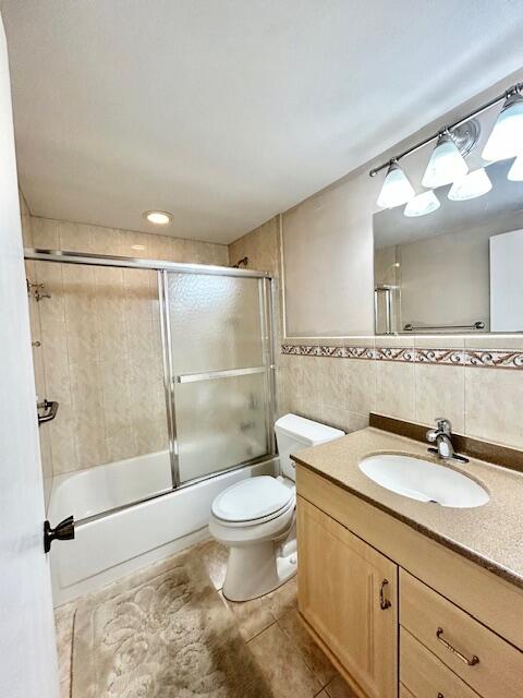 715 Normandy Lane Delray Beach, FL 33484 - Photo 26 of 43 a bathroom with a granite countertop sink toilet and shower