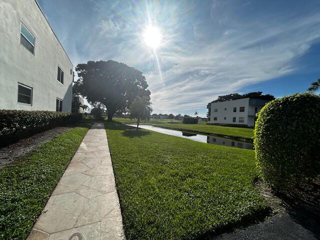 715 Normandy Lane Delray Beach, FL 33484 - Photo 32 of 43 a view of a garden with a pathway