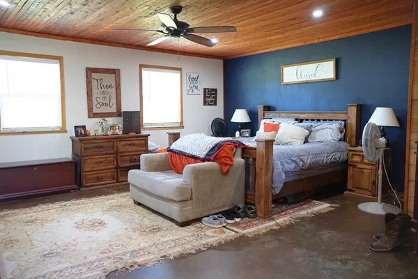 a bedroom with furniture and a rug