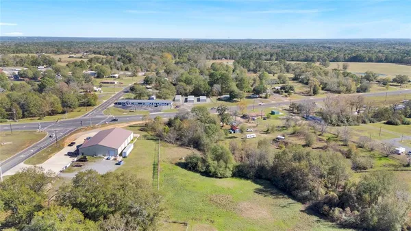 a view of an house with backyard and a tree