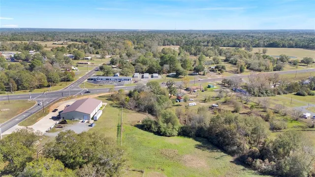 a view of an house with backyard and a tree