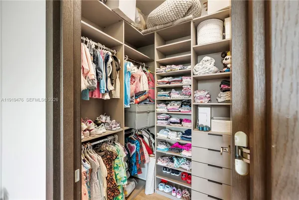 a bedroom with furniture and a large window