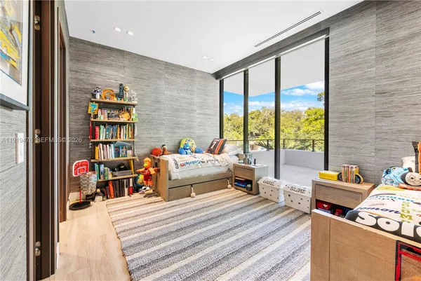 a bed sitting in a bedroom next to a window