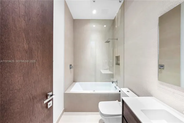 a view of a living room with furniture and a ceiling fan