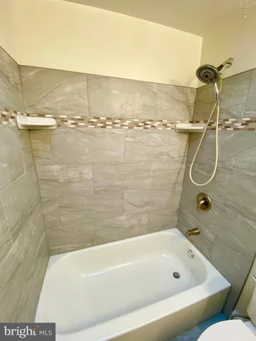 a bathroom with a bath tub and shower