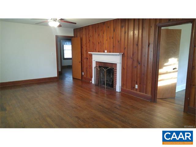 343 Lee Wayside Road Buckingham, VA 23921 - Photo 11 of 18 a open living room with a fireplace furniture and a window
