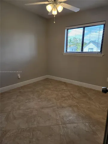a view of an empty room with a fan
