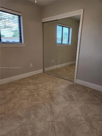 a room with water heater and a refrigerator