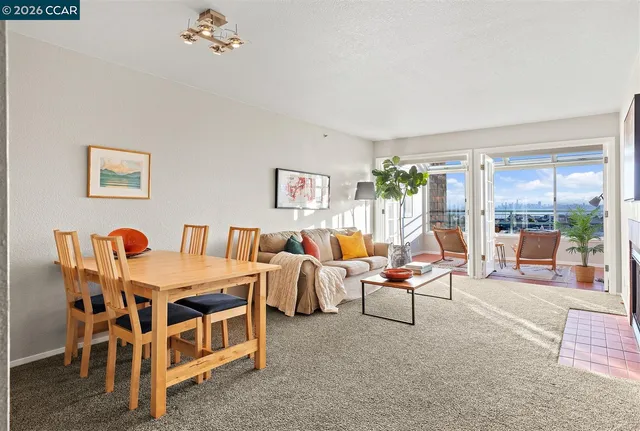 a living room with furniture gym equipment and large windows
