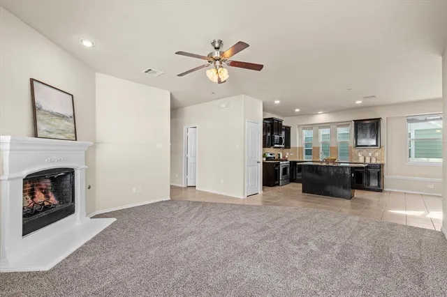 a view of a kitchen with a sink and a fireplace