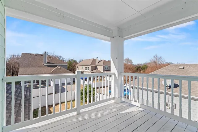 a view of a balcony with wooden floor