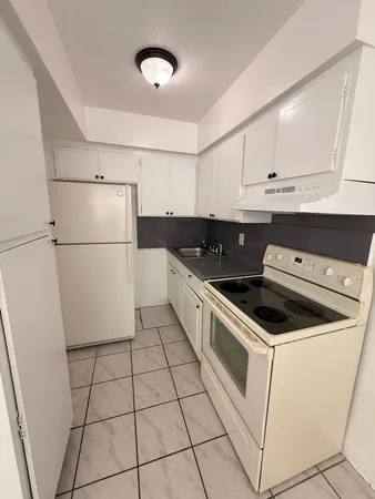 a kitchen with cabinets and white appliances