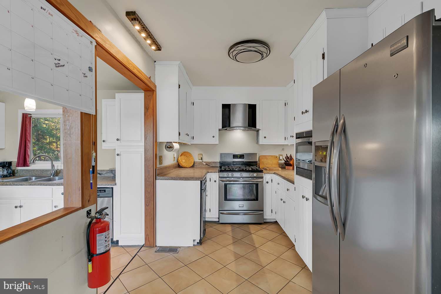 310 Brush Neck Road Susan, VA 23163 - Photo 10 of 70 a kitchen with stainless steel appliances granite countertop a refrigerator and a sink