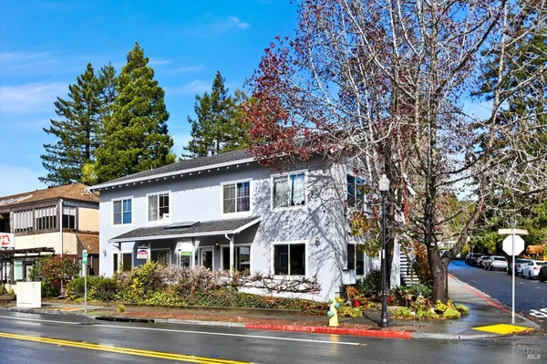 a front view of a house with lots of trees