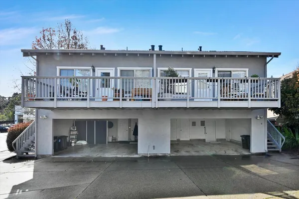 a front view of a building with glass windows and table