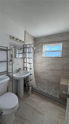 a bathroom with a sink toilet and shower