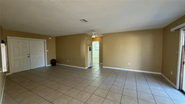 a view of a livingroom with an empty space and a window