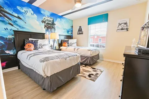 a bed room with a bed and a television