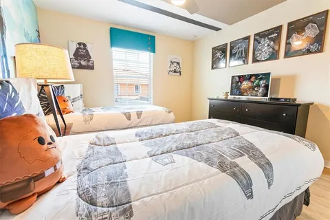 a bedroom with a bed and wooden floor