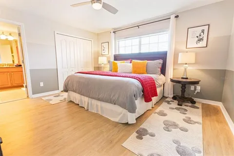 a spacious bedroom with a bed and a window